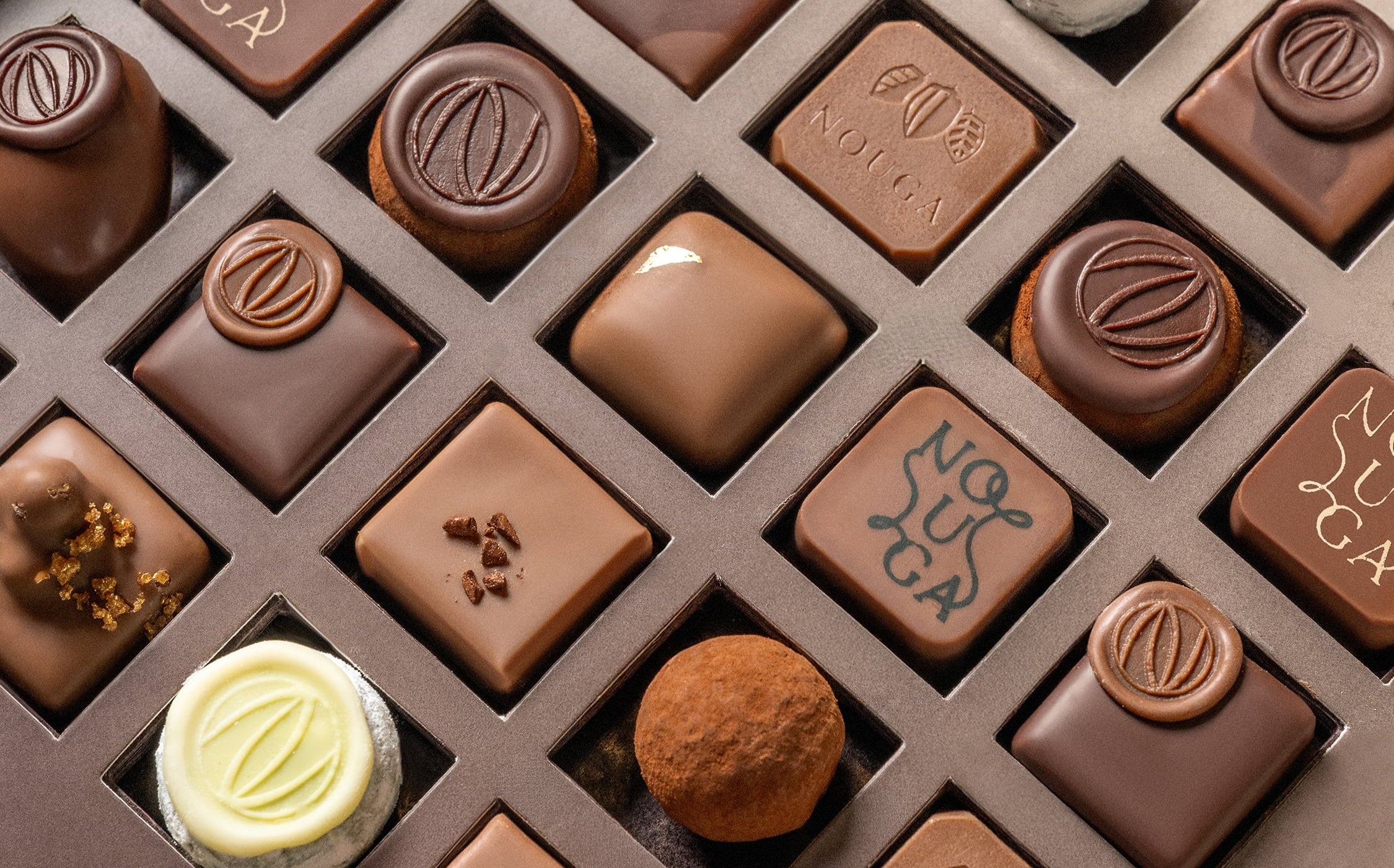 Assorted chocolates in a box with visible branding