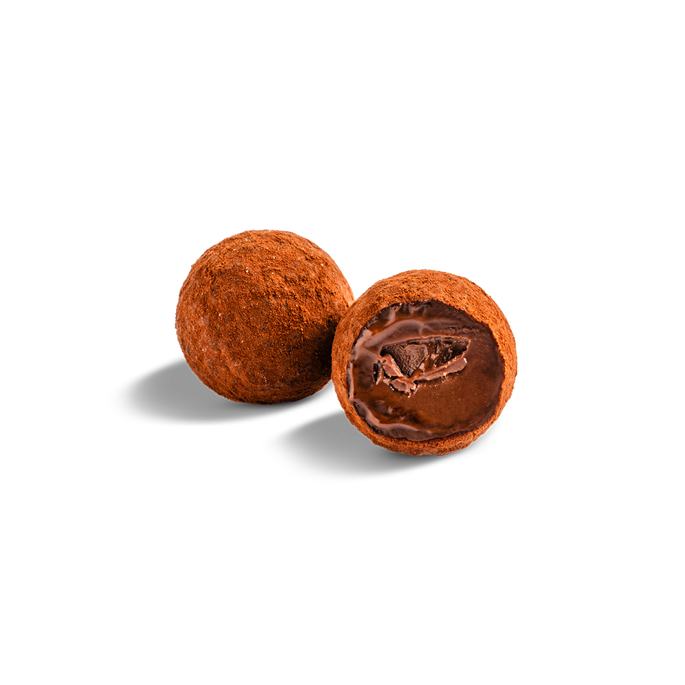 Two milk chocolate truffles on light background