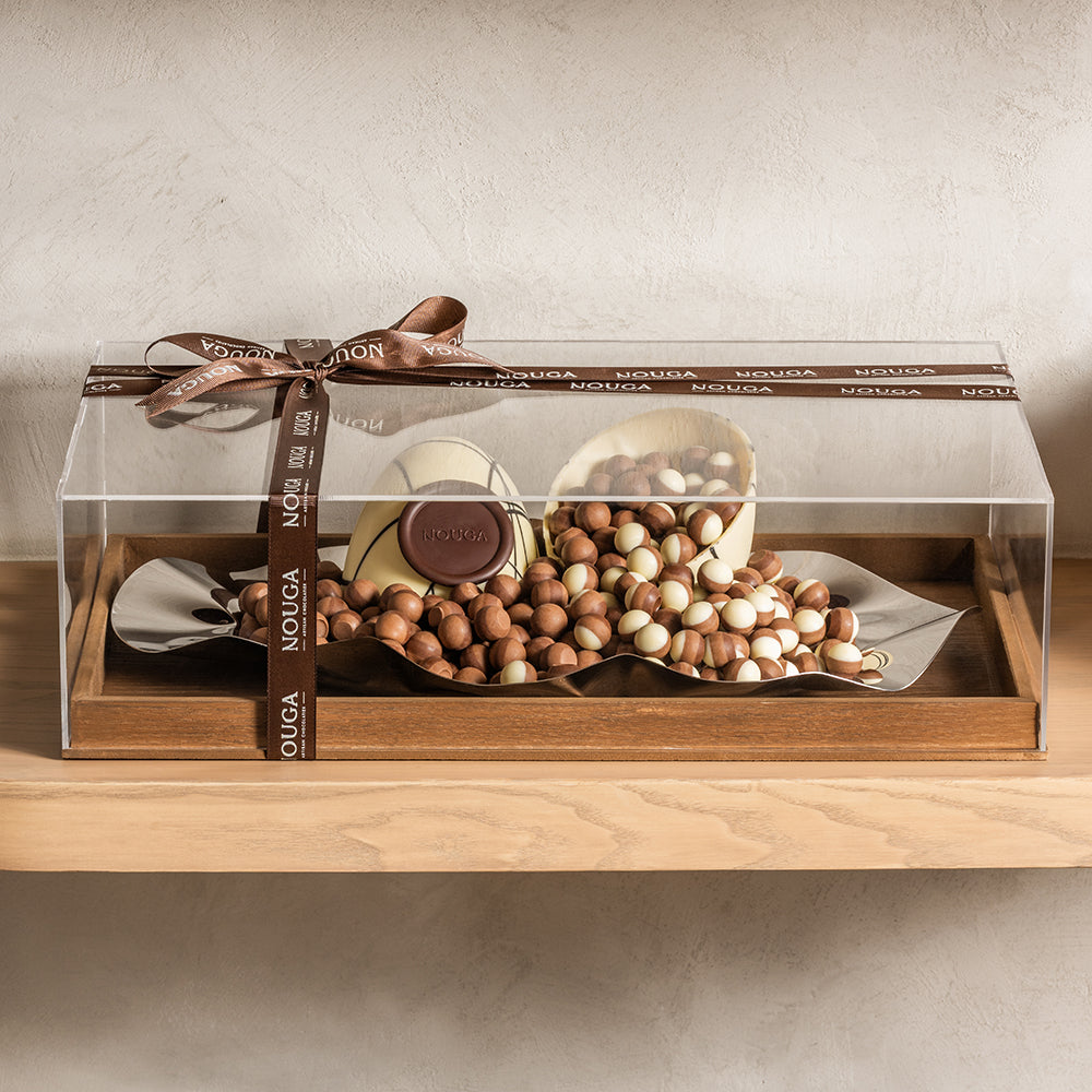 Cremino chocolate displayed on luxury tray with a clear cover on a wooden base. Wrapped with elegant ribbons.