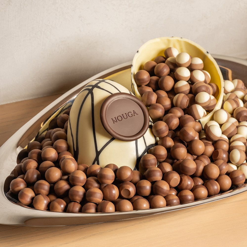 Decorative crystal bowl tray with chocolate treats on a glass table