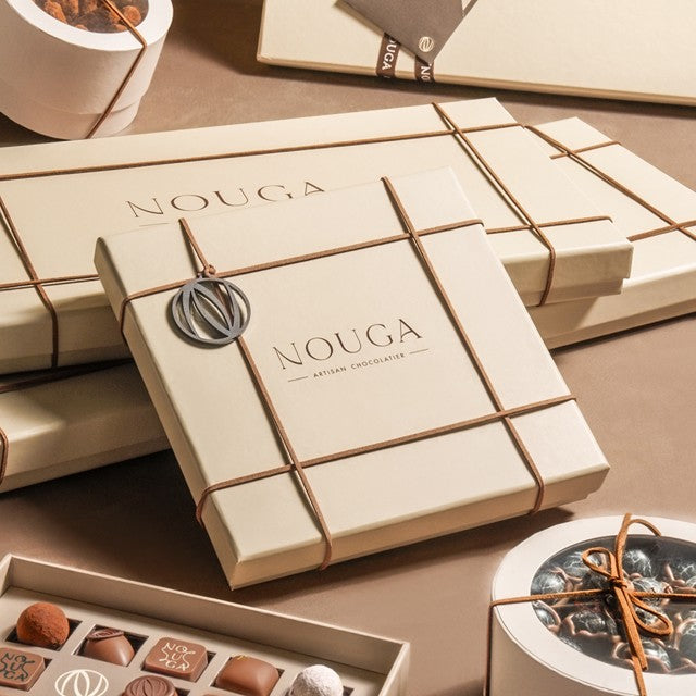 Nouga chocolate boxes with a focus on branding and product presentation.